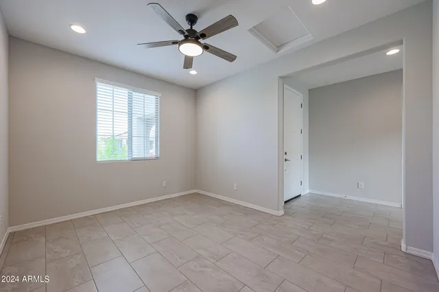 a view of a livingroom with a ceiling fan and window