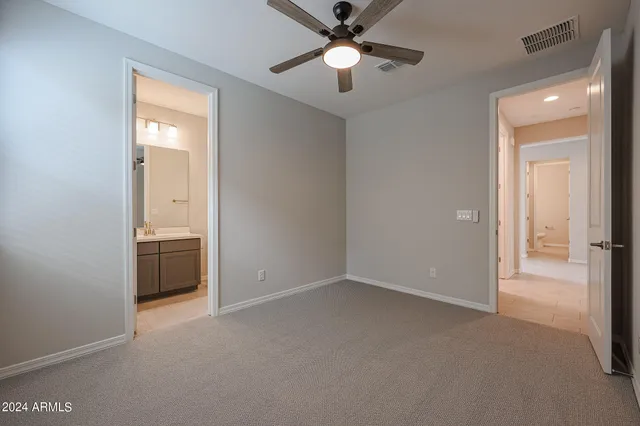 a view of a house with a yard and car parked