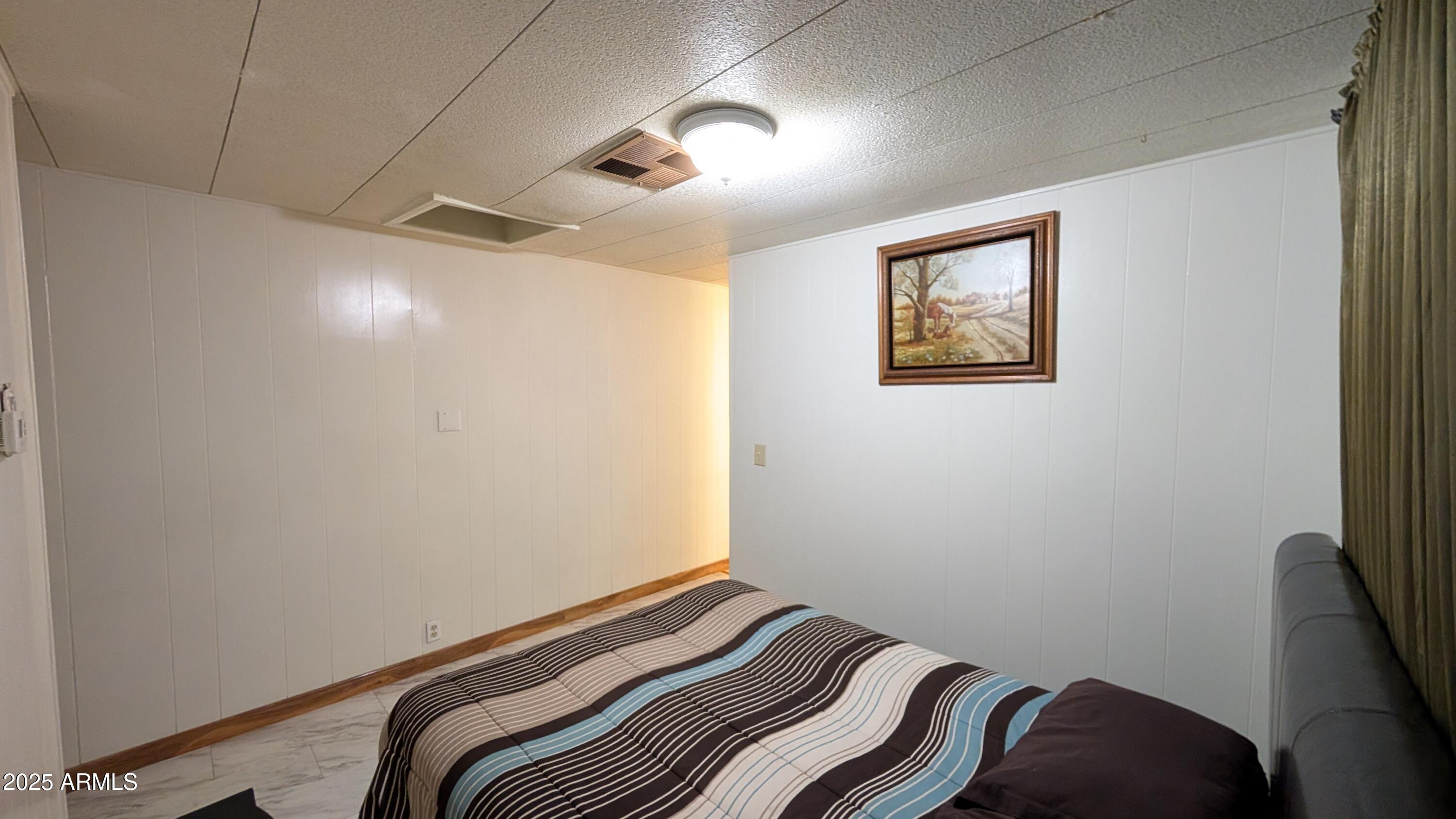 1250 East Bell Road, Unit 23 Phoenix, AZ 85022 - Photo 15 of 26 a bedroom with a bed and a painting on the wall