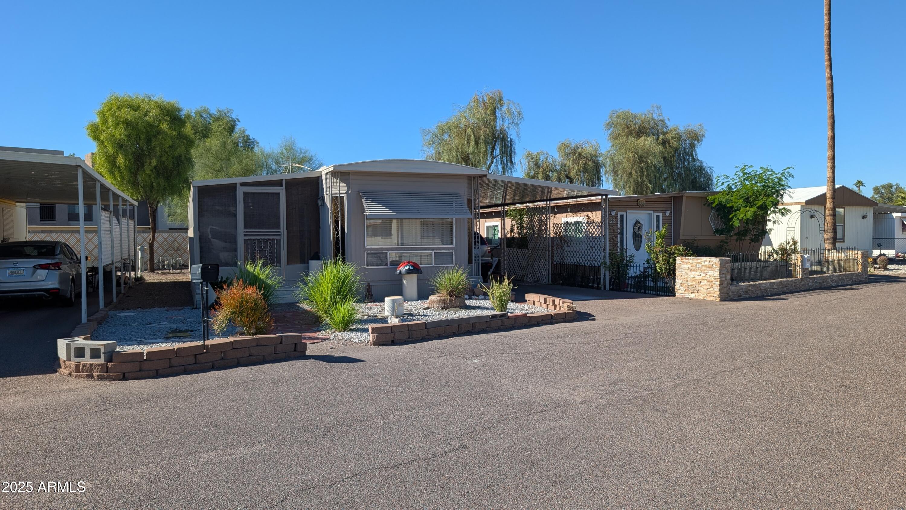 1250 East Bell Road, Unit 23 Phoenix, AZ 85022 - Photo 2 of 26 a view of a chair and tables in the patio
