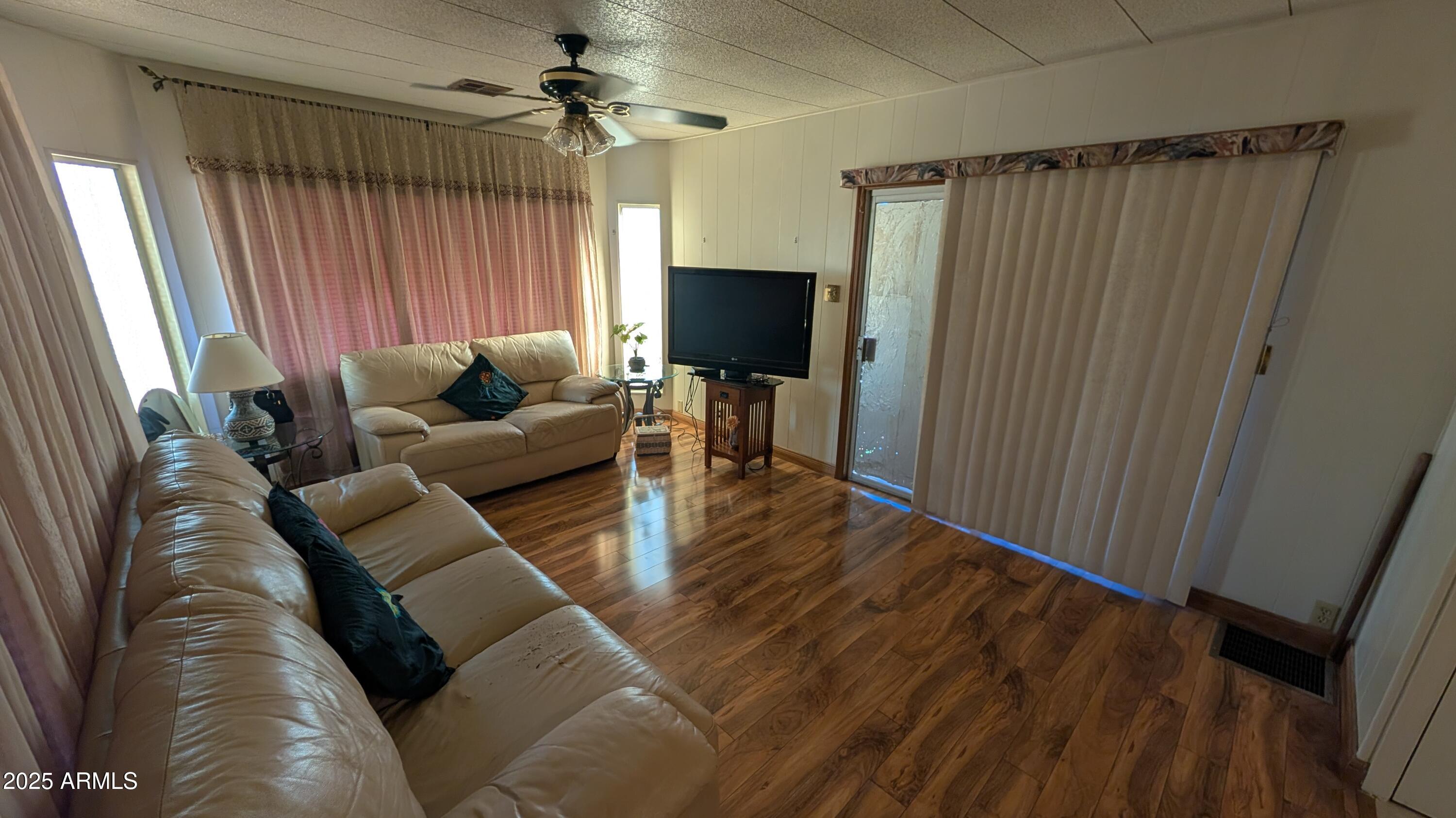1250 East Bell Road, Unit 23 Phoenix, AZ 85022 - Photo 8 of 26 a living room with furniture and a flat screen tv