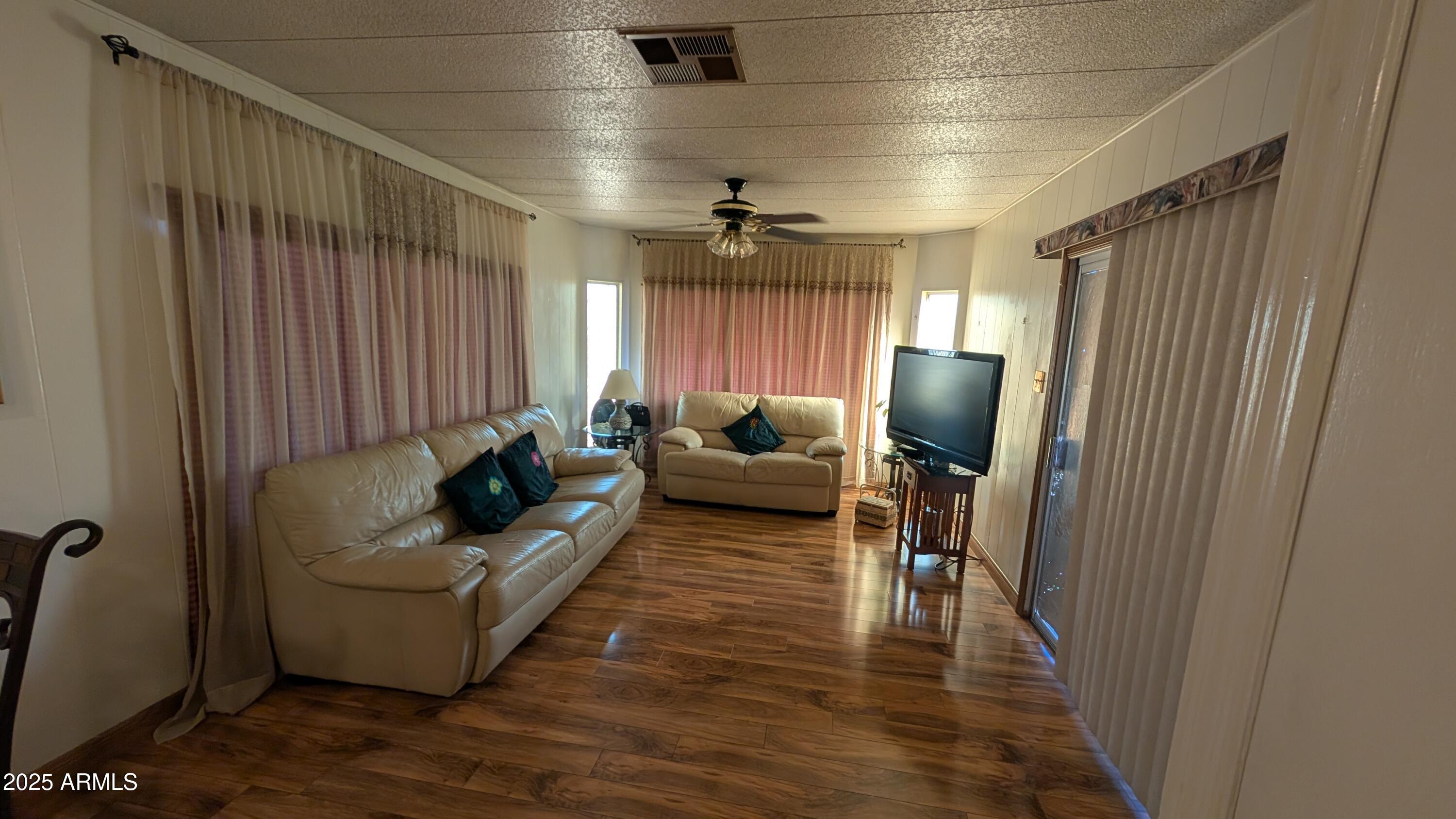 1250 East Bell Road, Unit 23 Phoenix, AZ 85022 - Photo 9 of 26 a living room with furniture and a flat screen tv