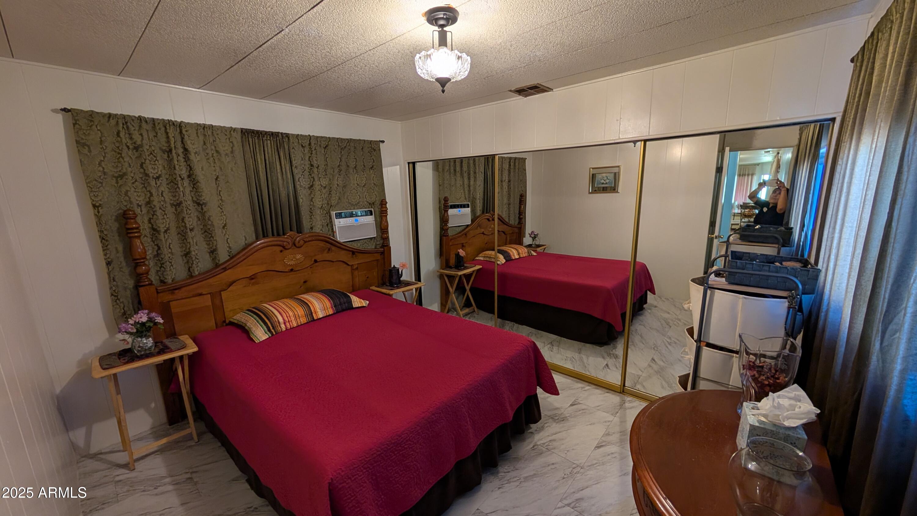 1250 East Bell Road, Unit 23 Phoenix, AZ 85022 - Photo 10 of 26 a bedroom with bed and a mirror