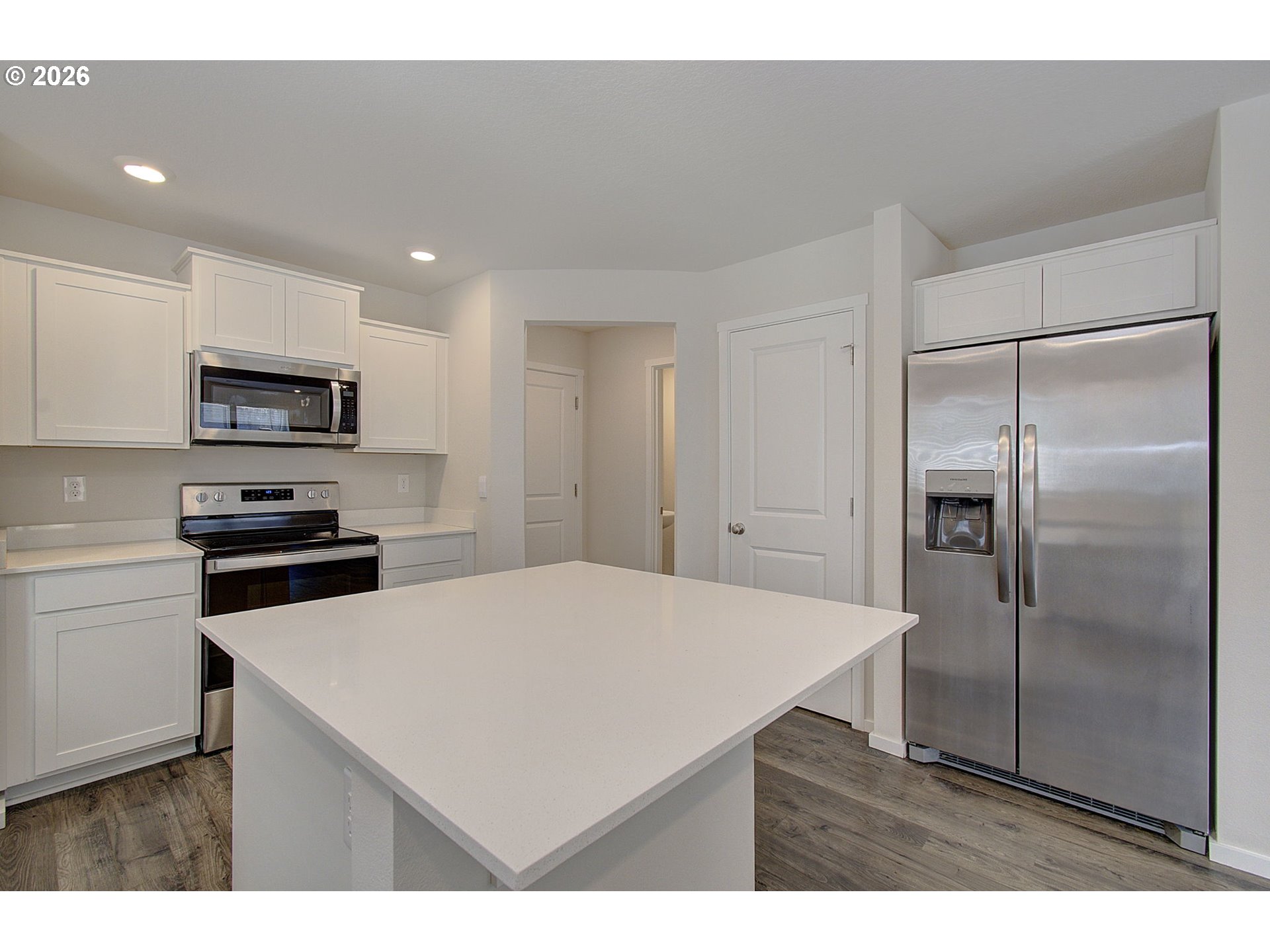 17402 Northwest 10th Place Ridgefield, WA 98642 - Photo 11 of 36 a kitchen with kitchen island a refrigerator sink and stove