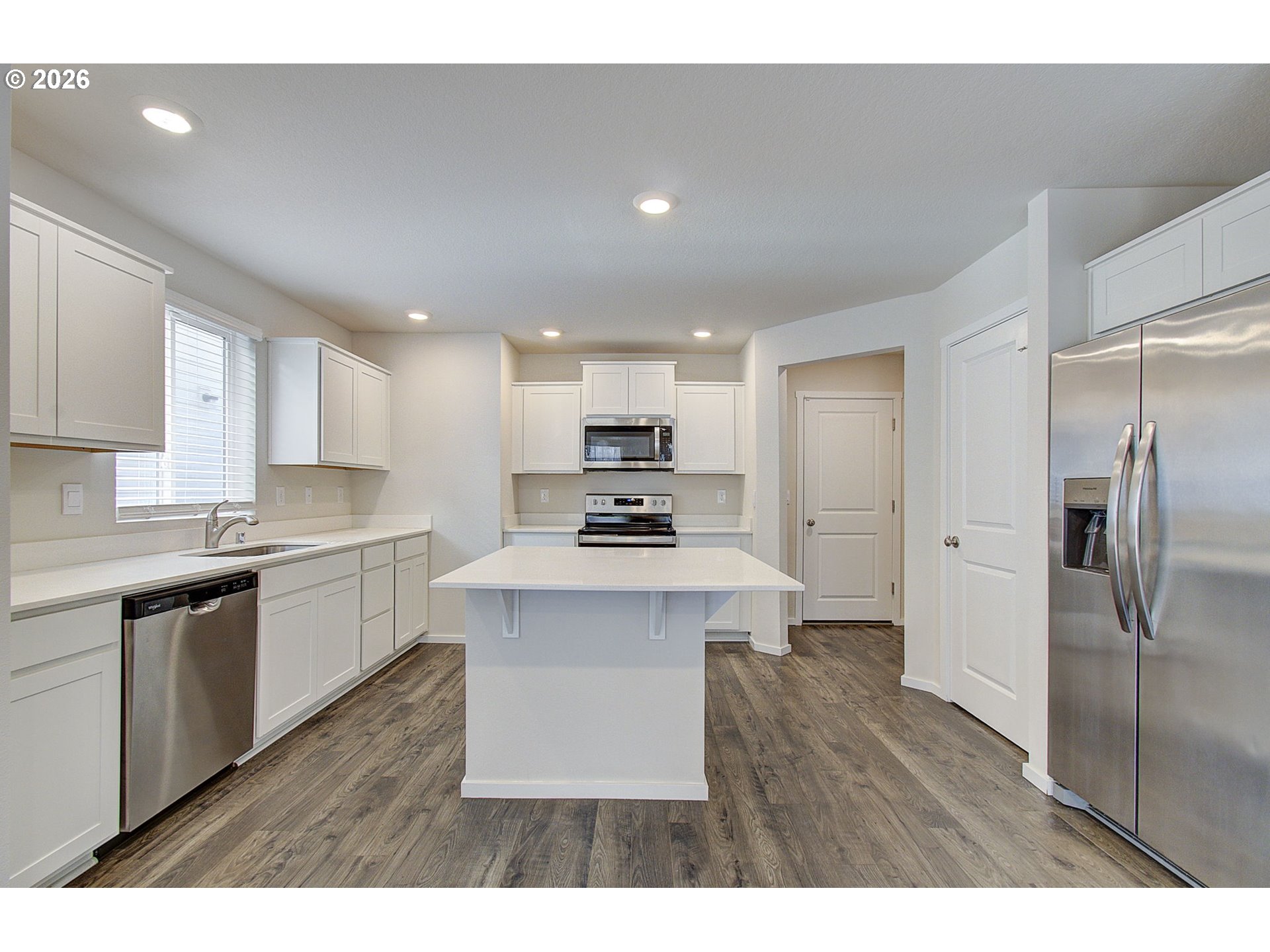 17402 Northwest 10th Place Ridgefield, WA 98642 - Photo 14 of 36 a kitchen with a sink stainless steel appliances and cabinets