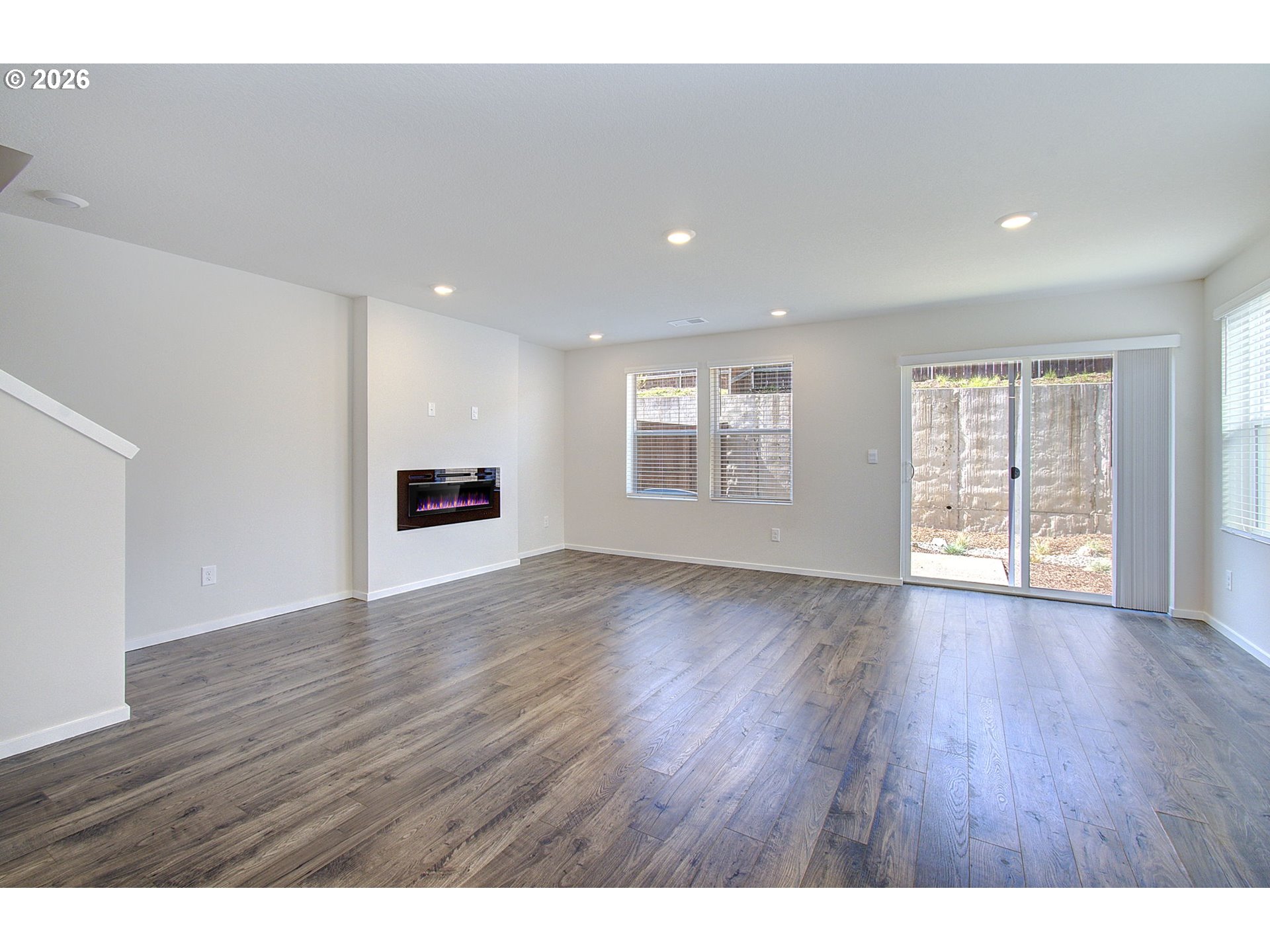 17402 Northwest 10th Place Ridgefield, WA 98642 - Photo 8 of 36 a view of an empty room with wooden floor and a window
