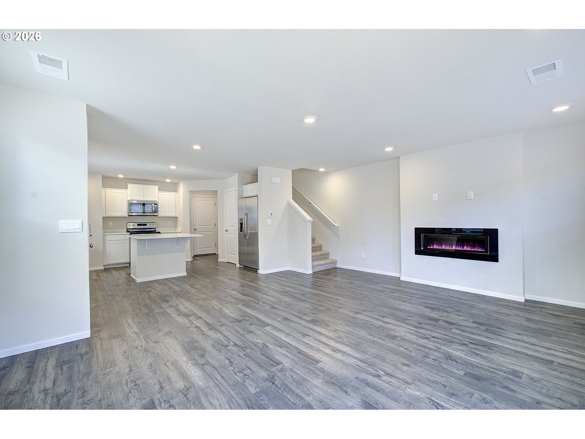 17402 Northwest 10th Place Ridgefield, WA 98642 - Photo 9 of 36 a view of a kitchen with a sink and a refrigerator