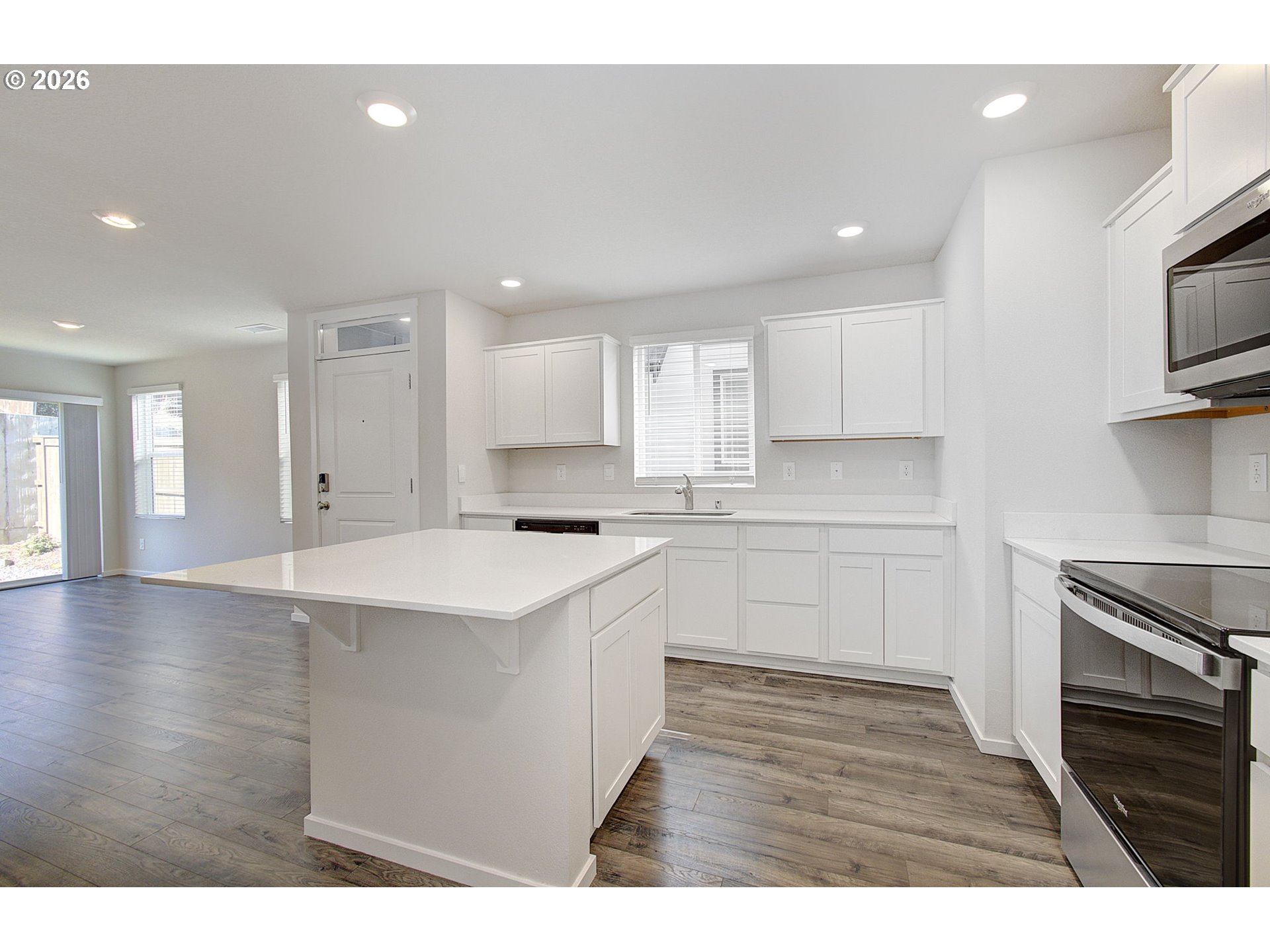 17402 Northwest 10th Place Ridgefield, WA 98642 - Photo 10 of 36 a kitchen with stainless steel appliances granite countertop a sink a stove and cabinets