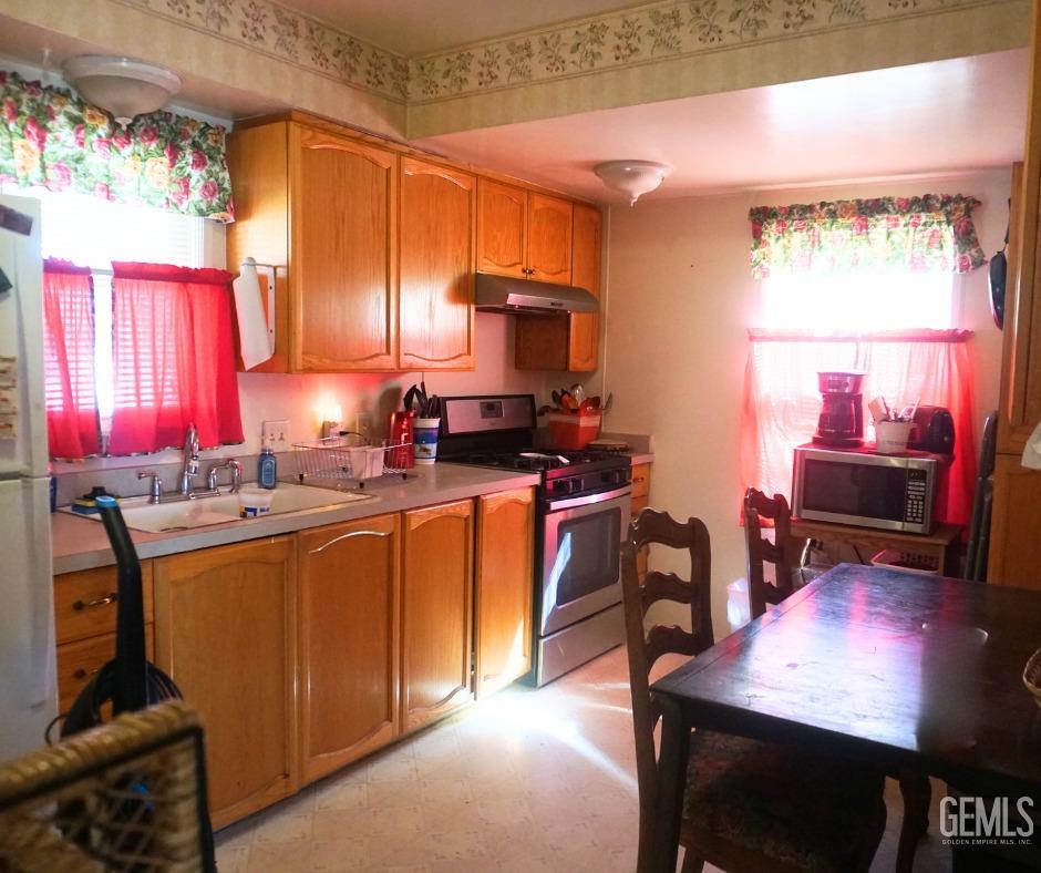 Undisclosed Address Bakersfield, CA 93306 - Photo 5 of 12 a kitchen with stainless steel appliances granite countertop sink stove top oven and cabinets