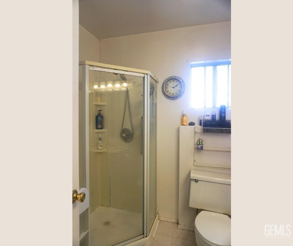 Undisclosed Address Bakersfield, CA 93306 - Photo 7 of 12 a bathroom with a toilet a sink and shower