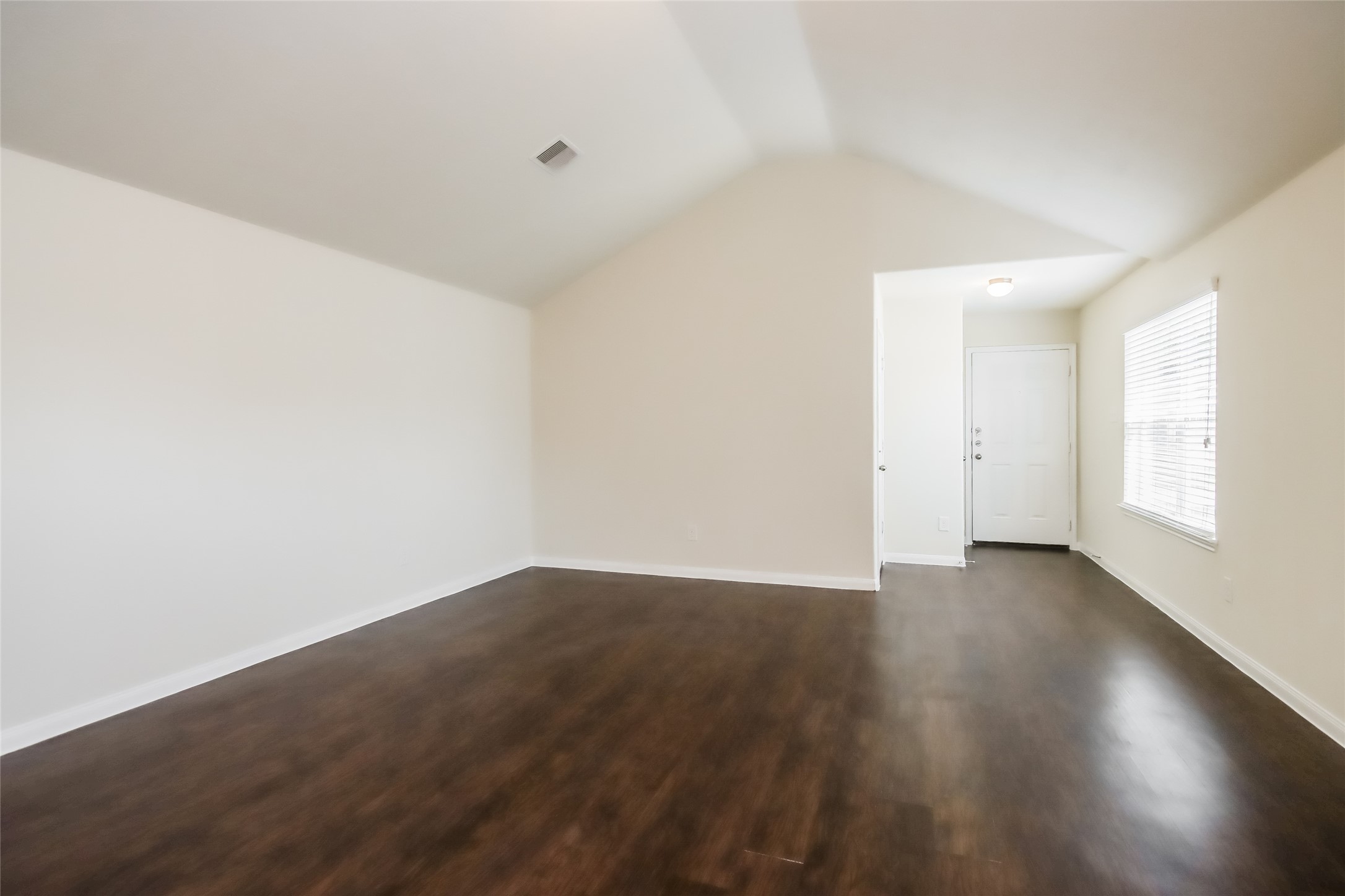 2418 High Island Way, Unit A Houston, TX 77073 - Photo 6 of 14 a view of an empty room with wooden floor and a window