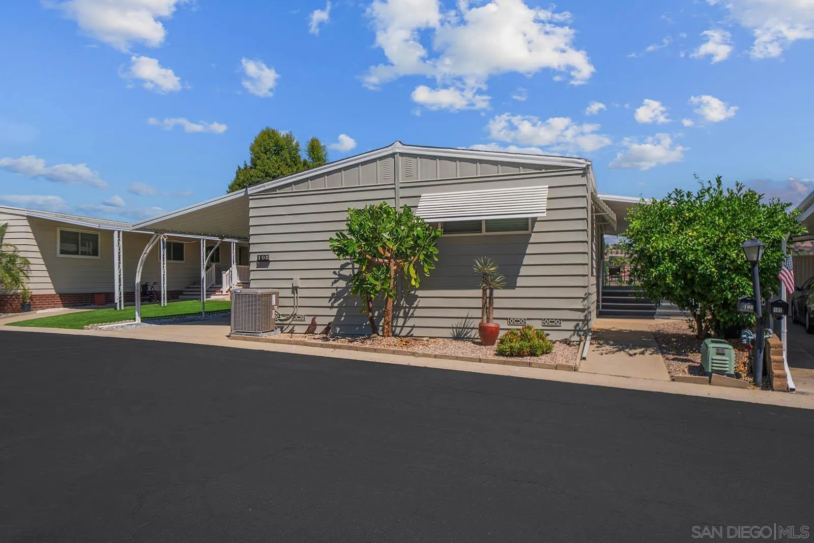 9500 Harritt Road, Unit 198 Lakeside, CA 92040 - Photo 2 of 48 a front view of a house with a yard and garage