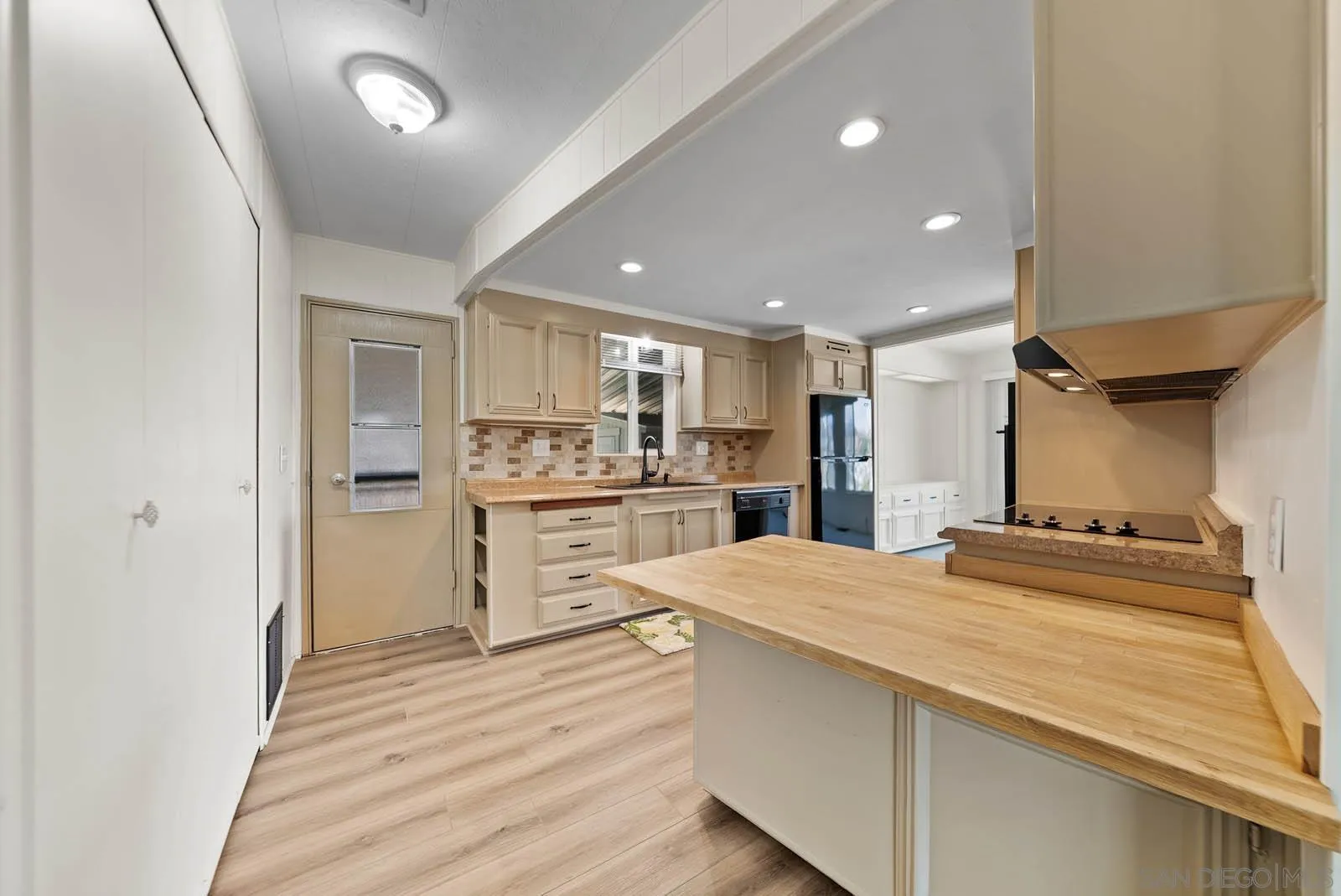 9500 Harritt Road, Unit 198 Lakeside, CA 92040 - Photo 22 of 48 a large kitchen with kitchen island a sink stainless steel appliances and cabinets