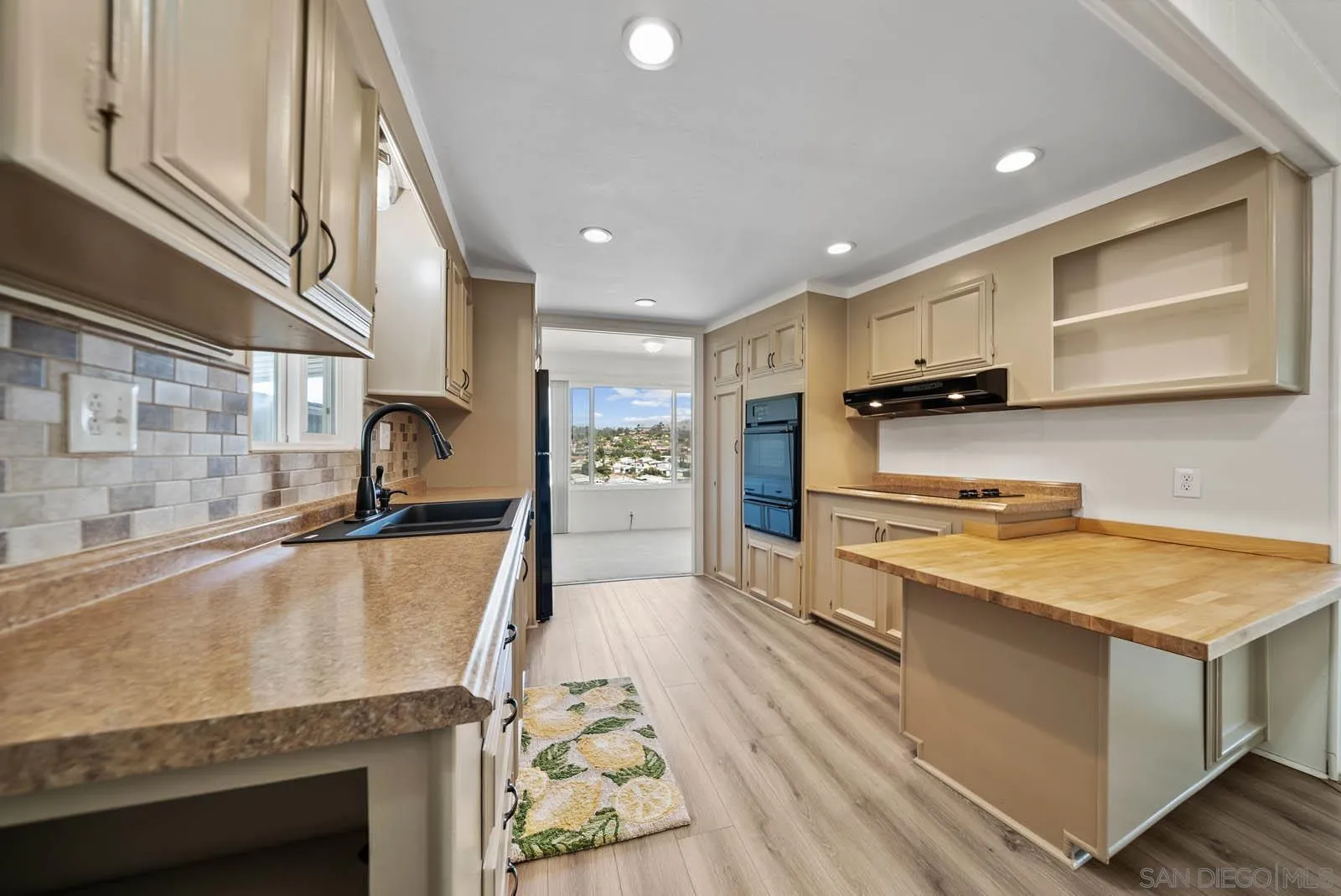 9500 Harritt Road, Unit 198 Lakeside, CA 92040 - Photo 23 of 48 a large kitchen with stainless steel appliances granite countertop a lot of counter space and wooden floor