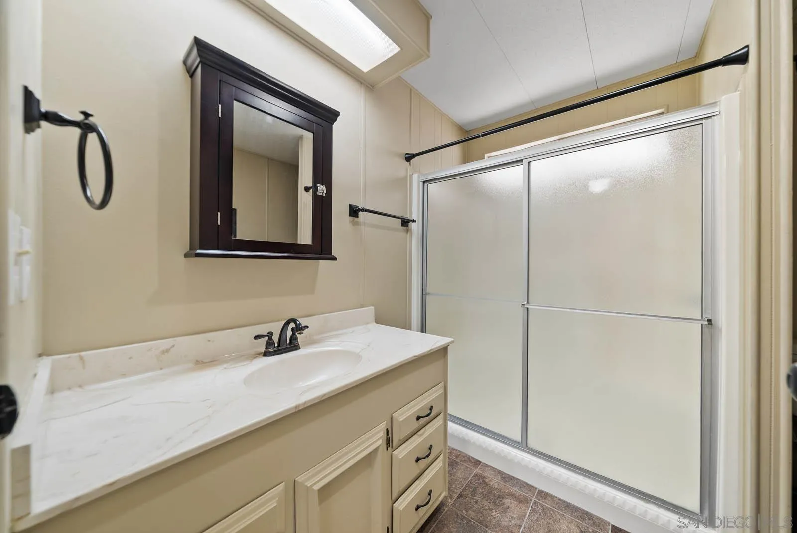 9500 Harritt Road, Unit 198 Lakeside, CA 92040 - Photo 32 of 48 a bathroom with a shower sink and mirror