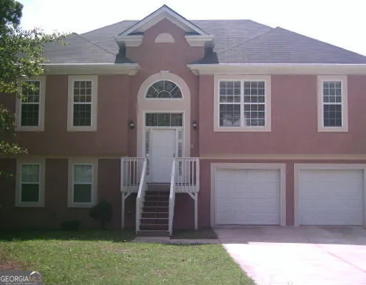 a front view of a house with garden