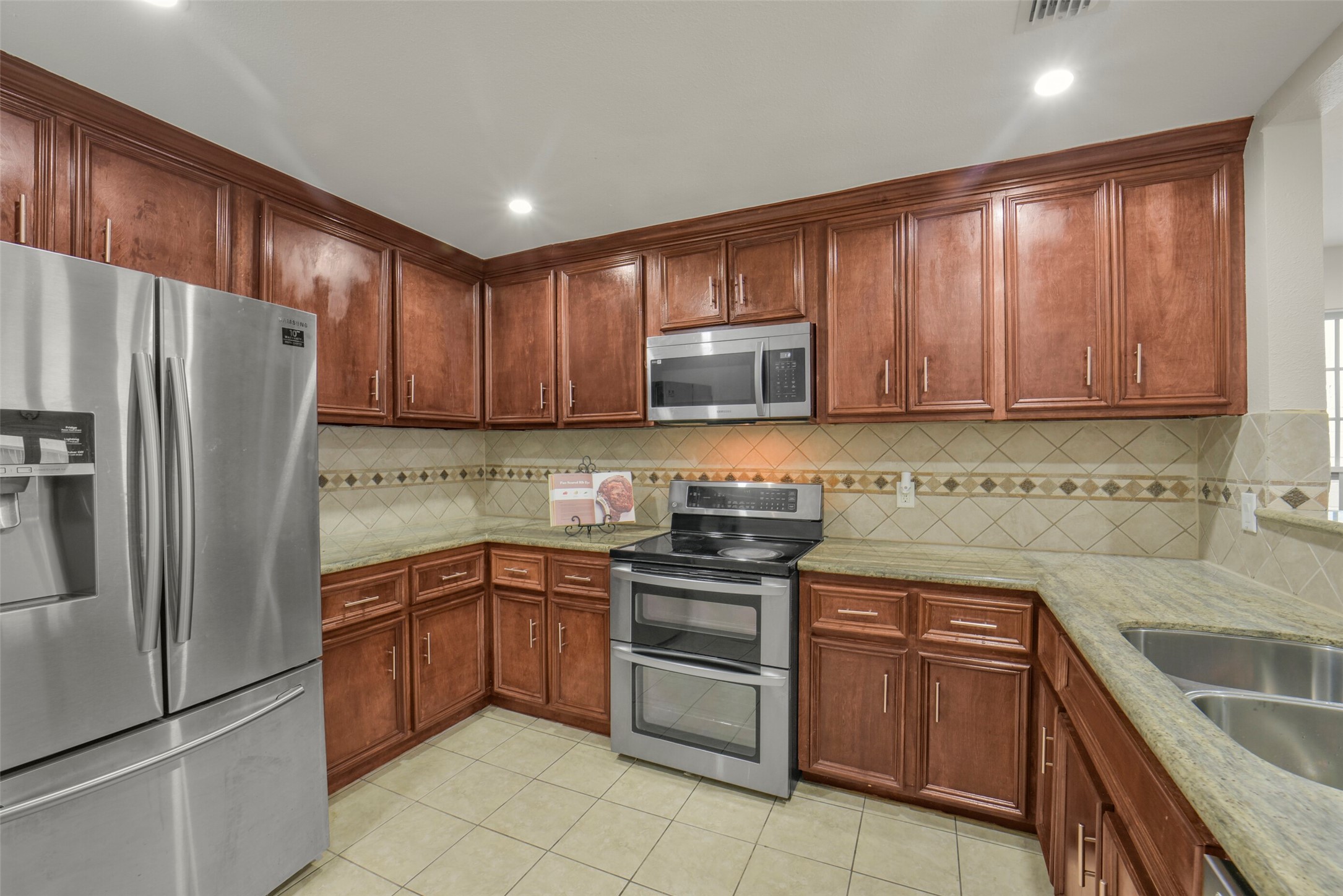 5707 Innsbruck Street Bellaire, TX 77401 - Photo 5 of 35 Spacious kitchen featuring tile floors, a double oven range and abundant cabinetry for all your storage needs.