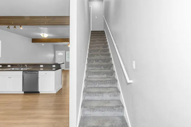 a view of entryway and hall with wooden floor