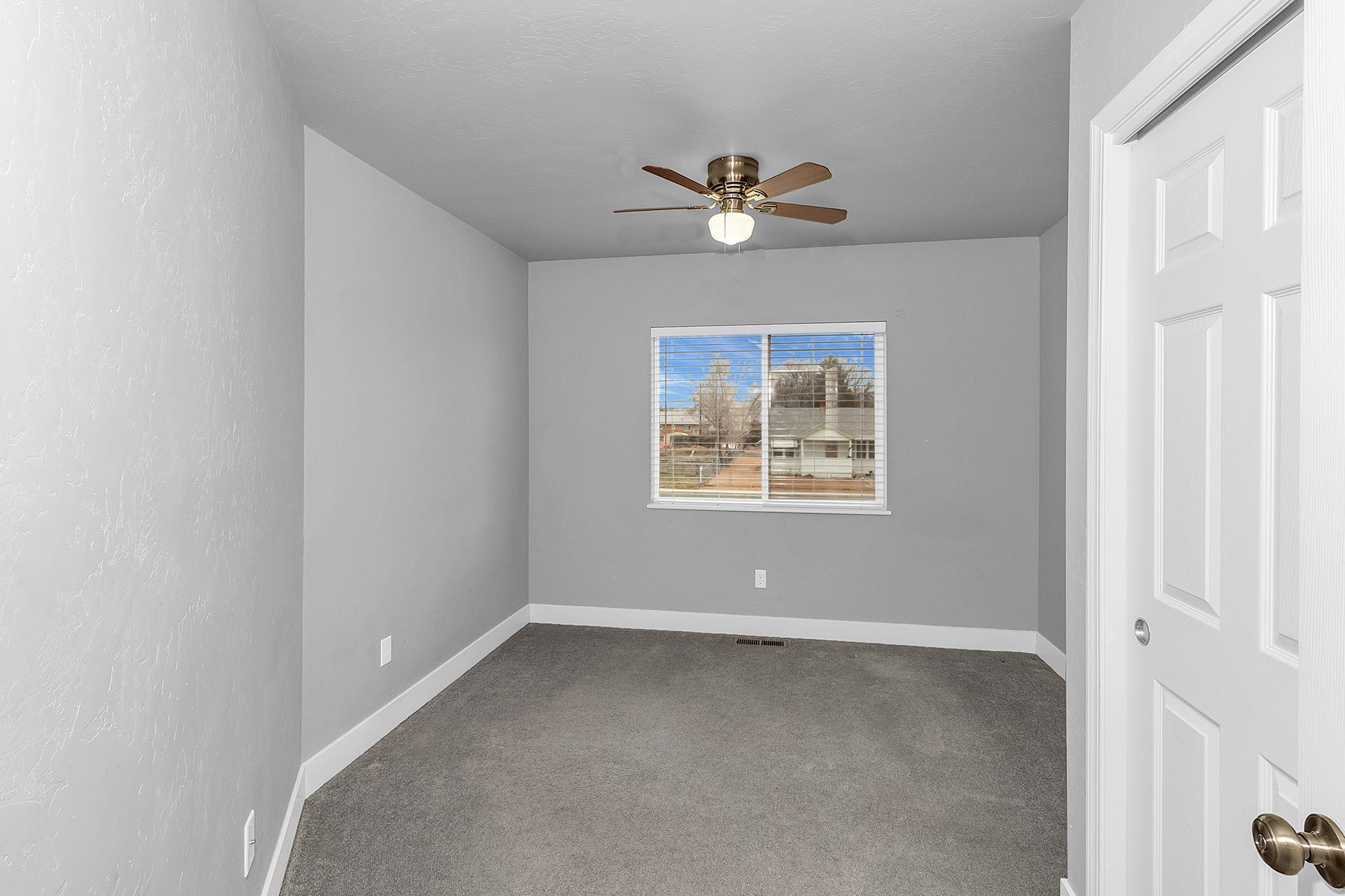 1309 North 16th Street, Unit 3 Grand Junction, CO 81501 - Photo 17 of 25 an empty room with a window and ceiling fan
