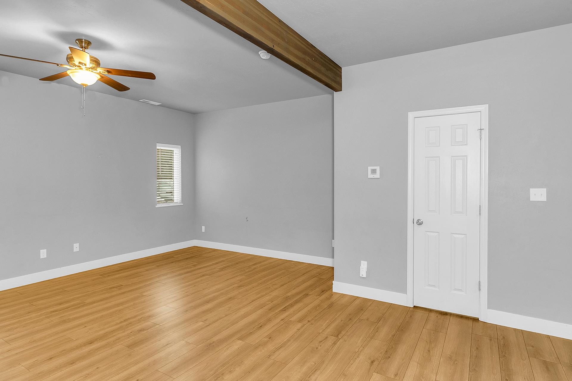 1309 North 16th Street, Unit 3 Grand Junction, CO 81501 - Photo 6 of 25 a view of an empty room with wooden floor and a window