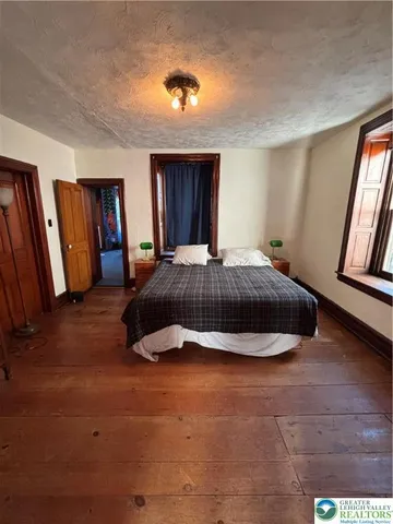 a bedroom with a bed and a window