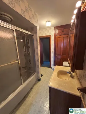 a bathroom with a sink and mirror