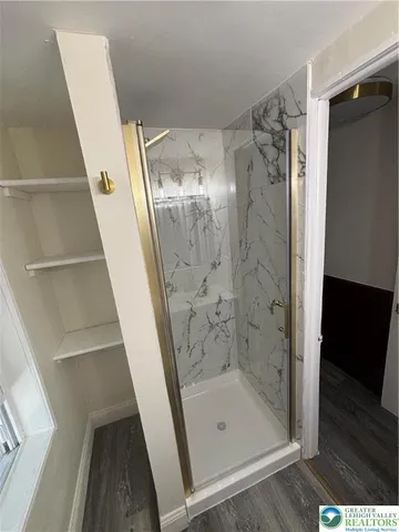 a bathroom with a glass door shower and a sink