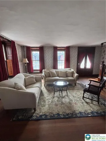 a living room with furniture a rug and a fireplace