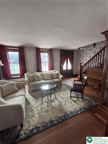 a living room with furniture a lamp and a fireplace