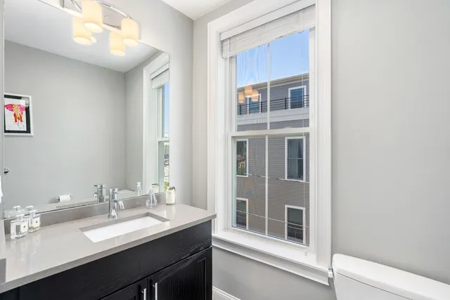 a bathroom with a sink vanity and a mirror