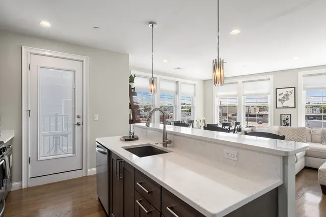 a kitchen with counter top space a sink and appliances