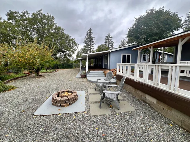 a living room with furniture pool table and a potted plant