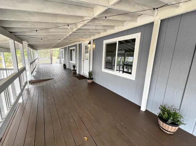 a large white kitchen with sink and stainless steel appliances
