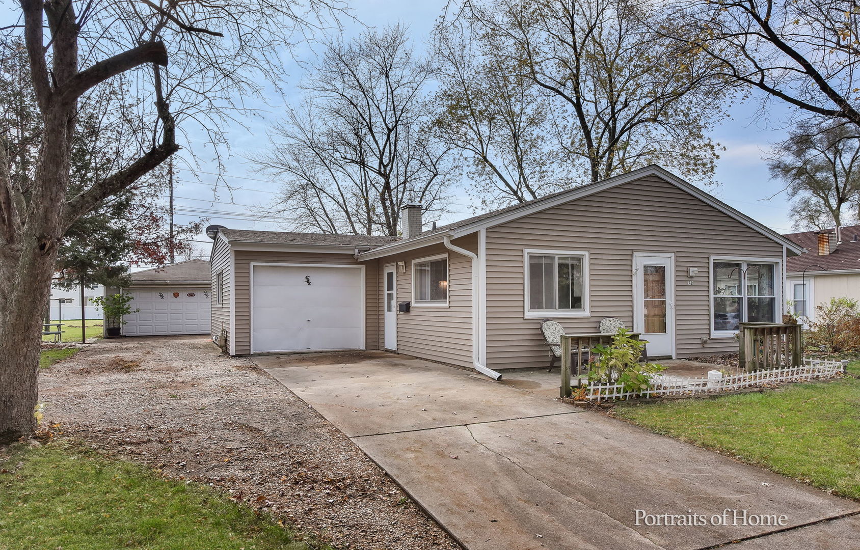 a front view of house with yard outdoor seating and barbeque oven