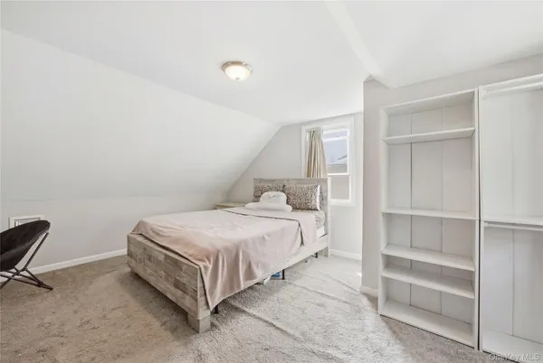 a bed room with a bed and a window