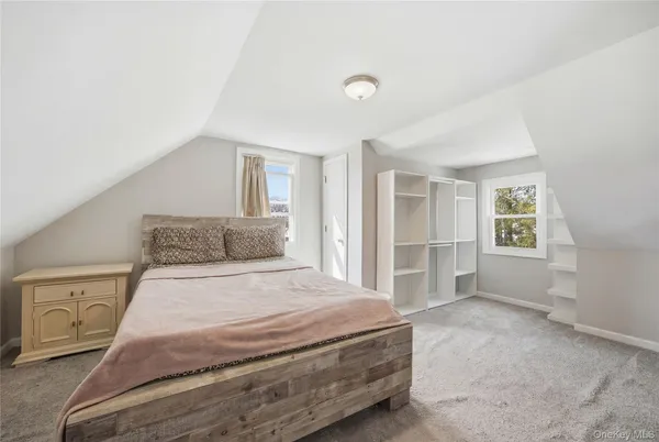 a spacious bedroom with a bed and a cabinets