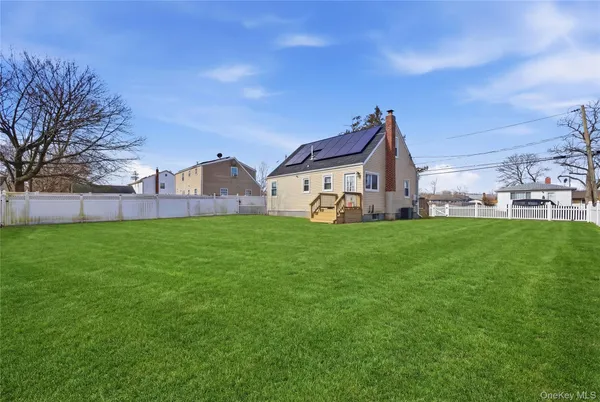 a view of a house with a yard and porch