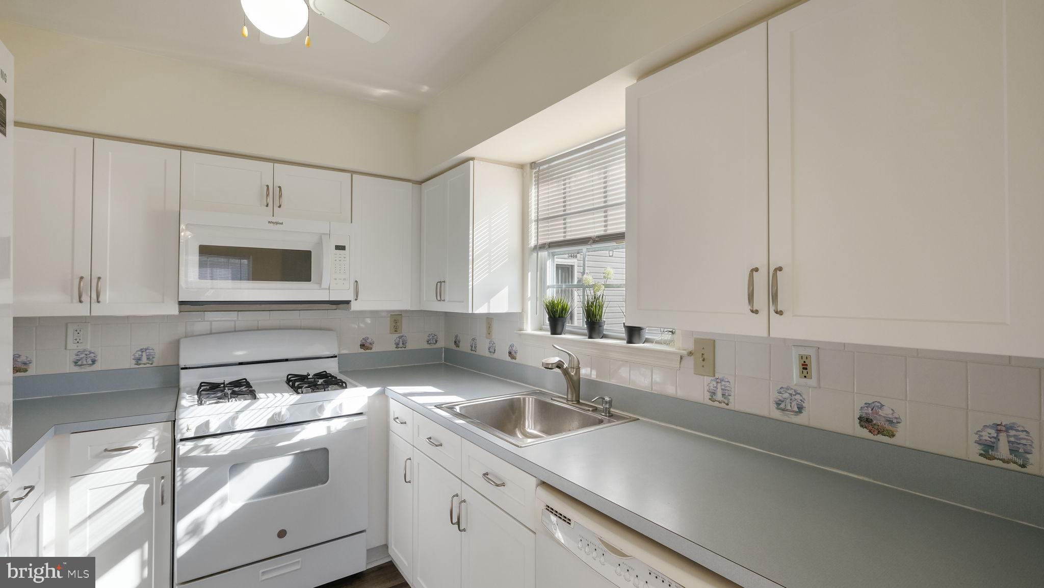 5480 Rinker Circle Doylestown, PA 18902 - Photo 11 of 23 a kitchen with a sink stove top oven and cabinets
