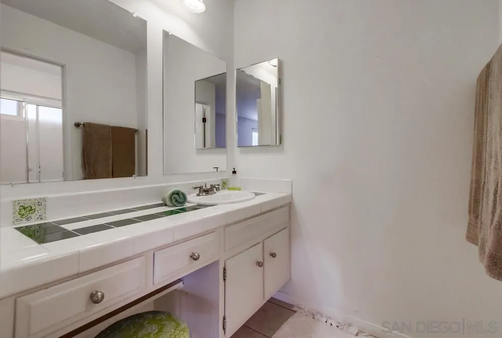 14759 Alando Place Poway, CA 92064 - Photo 13 of 30 a bathroom with a double vanity sink and mirror