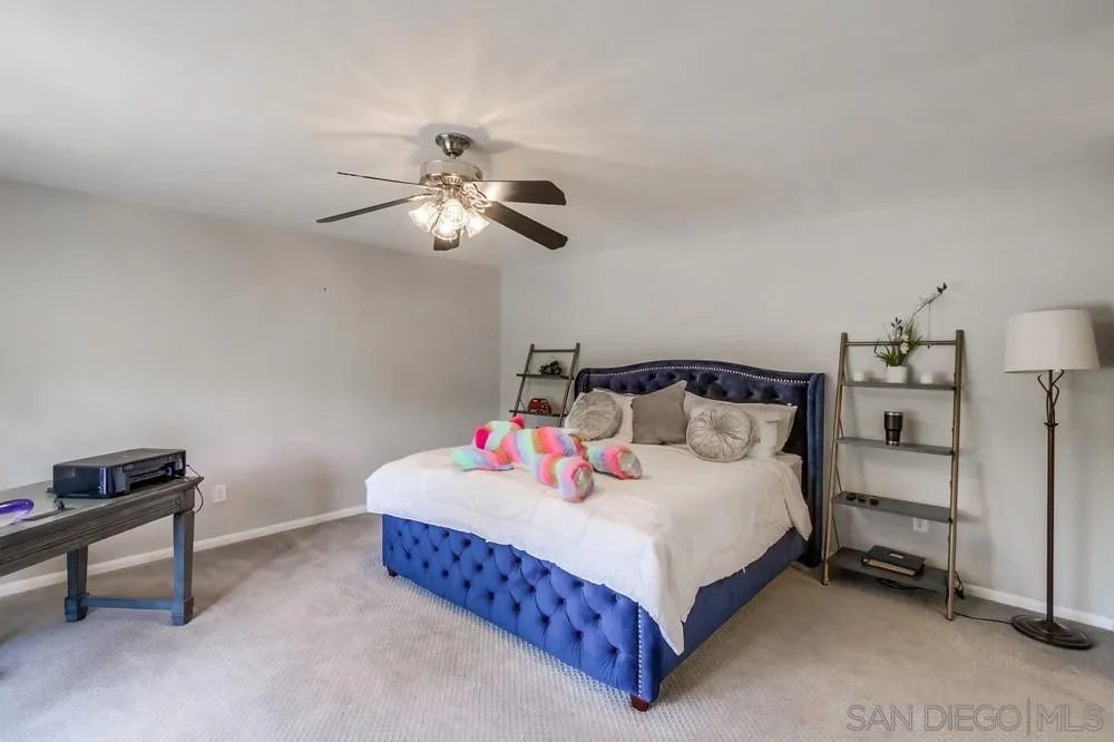 14759 Alando Place Poway, CA 92064 - Photo 15 of 30 a bedroom with a bed and a chandelier
