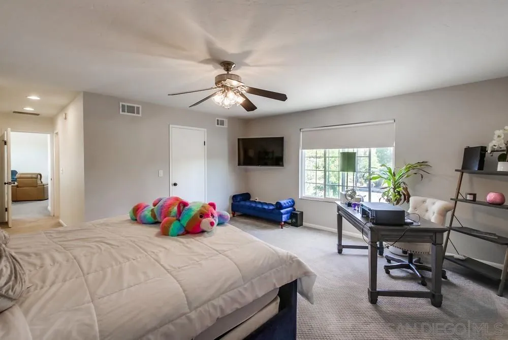14759 Alando Place Poway, CA 92064 - Photo 16 of 30 a bedroom with a bed a large window and furniture