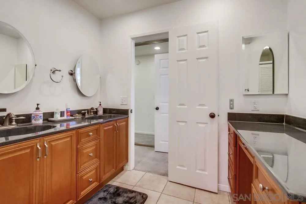 14759 Alando Place Poway, CA 92064 - Photo 19 of 30 a spacious bathroom with a double vanity sink a mirror and shower