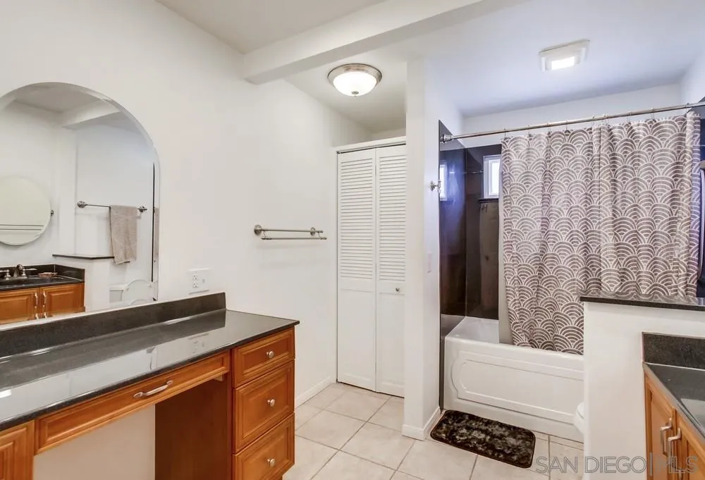 14759 Alando Place Poway, CA 92064 - Photo 20 of 30 a spacious bathroom with a double vanity sink a large mirror and shower