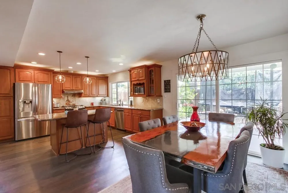 14759 Alando Place Poway, CA 92064 - Photo 7 of 30 a view of a dining room and livingroom with furniture wooden floor a chandelier