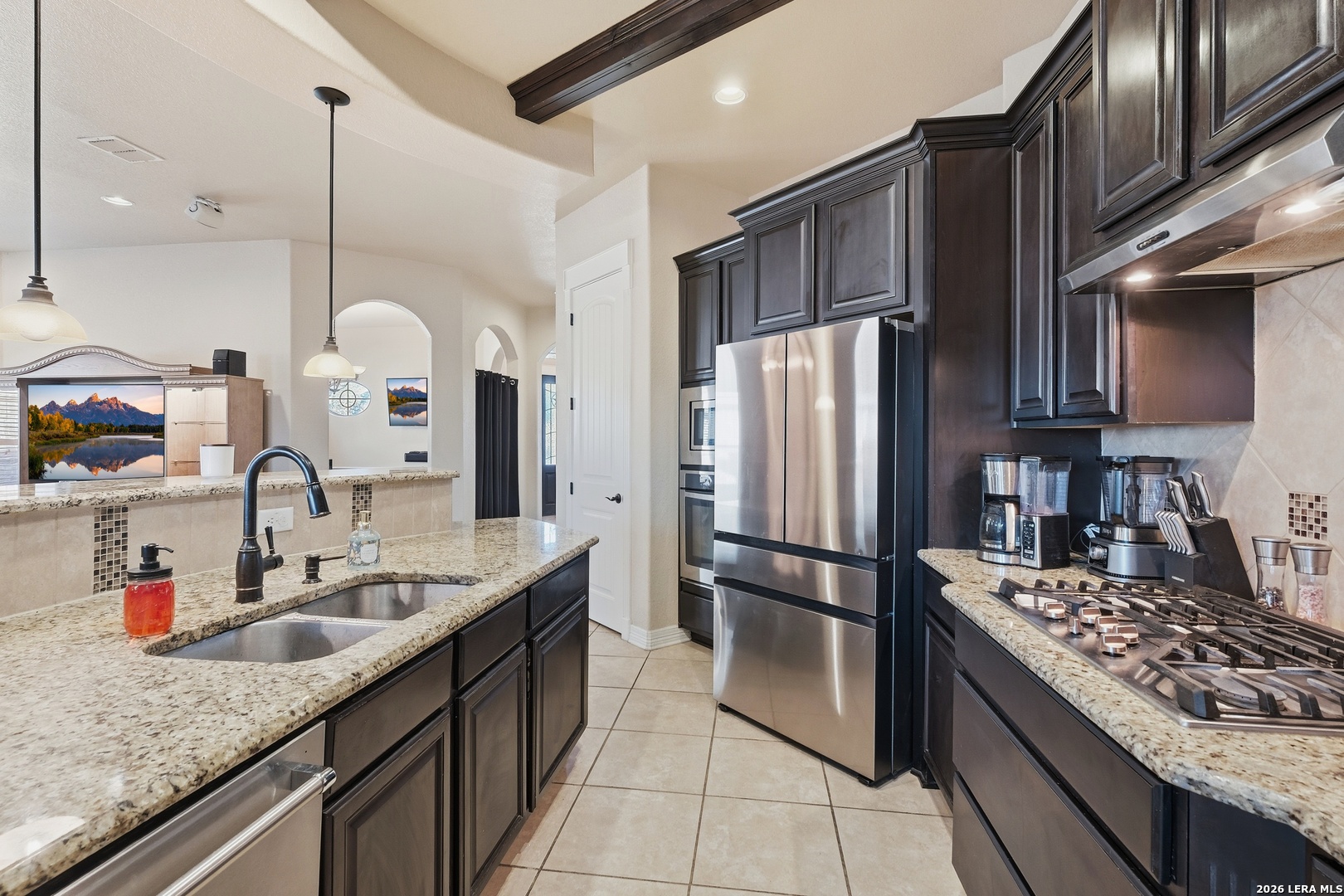 14715 Rifleman Road San Antonio, TX 78254 - Photo 11 of 30 a kitchen with stainless steel appliances granite countertop a sink stove and refrigerator