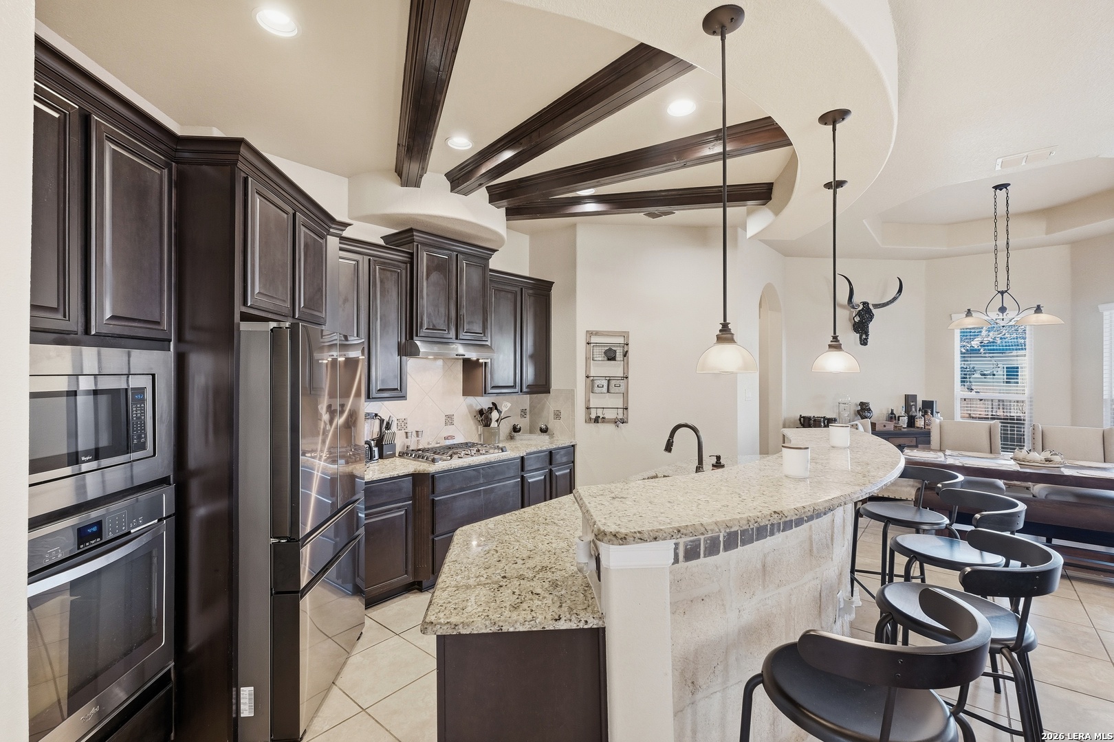 14715 Rifleman Road San Antonio, TX 78254 - Photo 12 of 30 a kitchen with granite countertop lots of counter top space and stainless steel appliances
