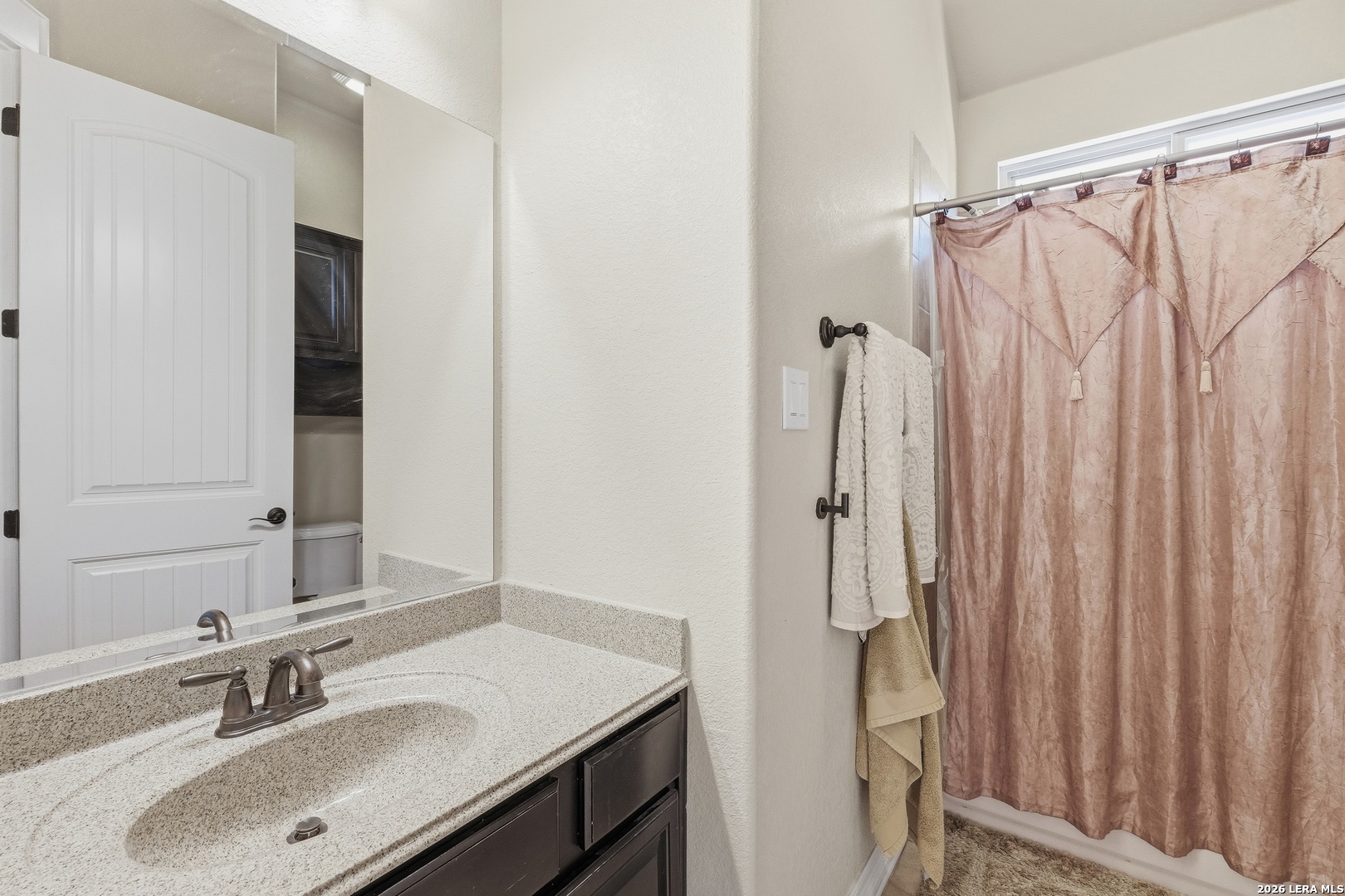 14715 Rifleman Road San Antonio, TX 78254 - Photo 27 of 30 a bathroom with a sink vanity granite tub and shower