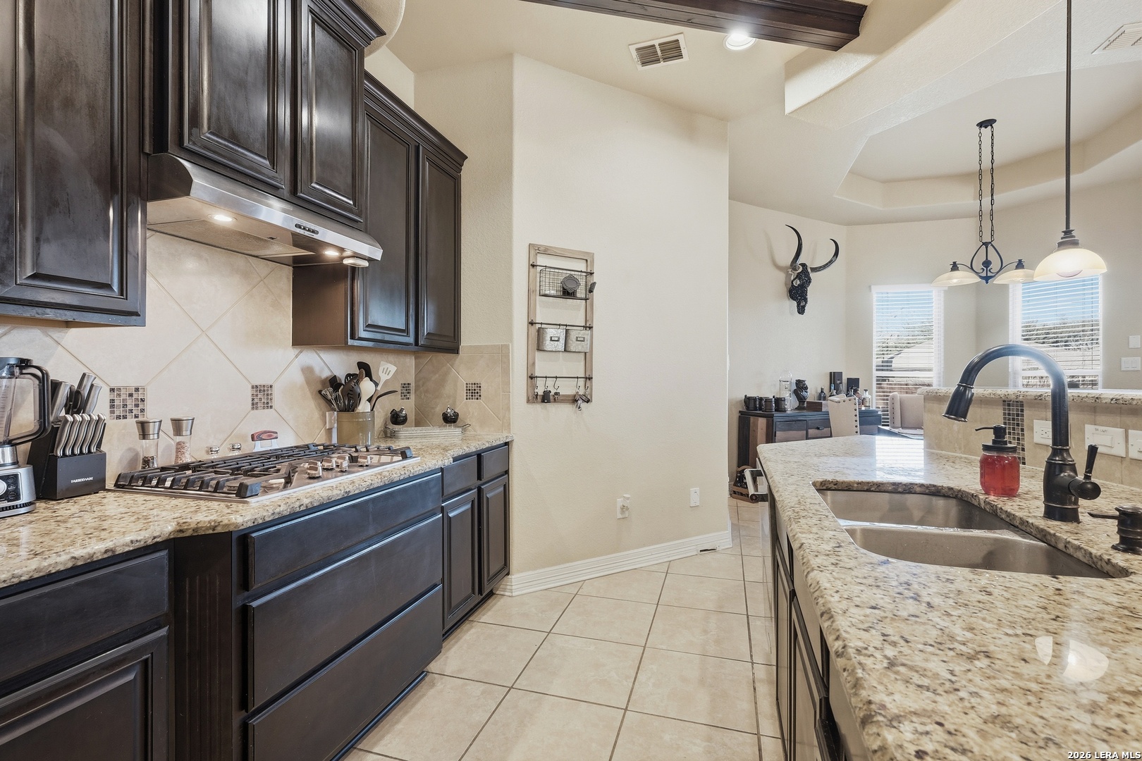 14715 Rifleman Road San Antonio, TX 78254 - Photo 10 of 30 a kitchen with stainless steel appliances granite countertop a sink stove and cabinets