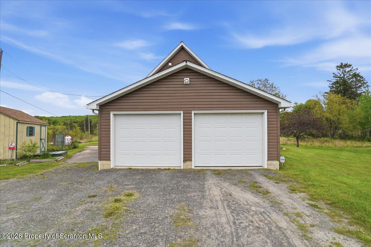 5231 Fiddle Lake Road Thompson, PA 18465 - Photo 24 of 34 a front view of house with garage and yard