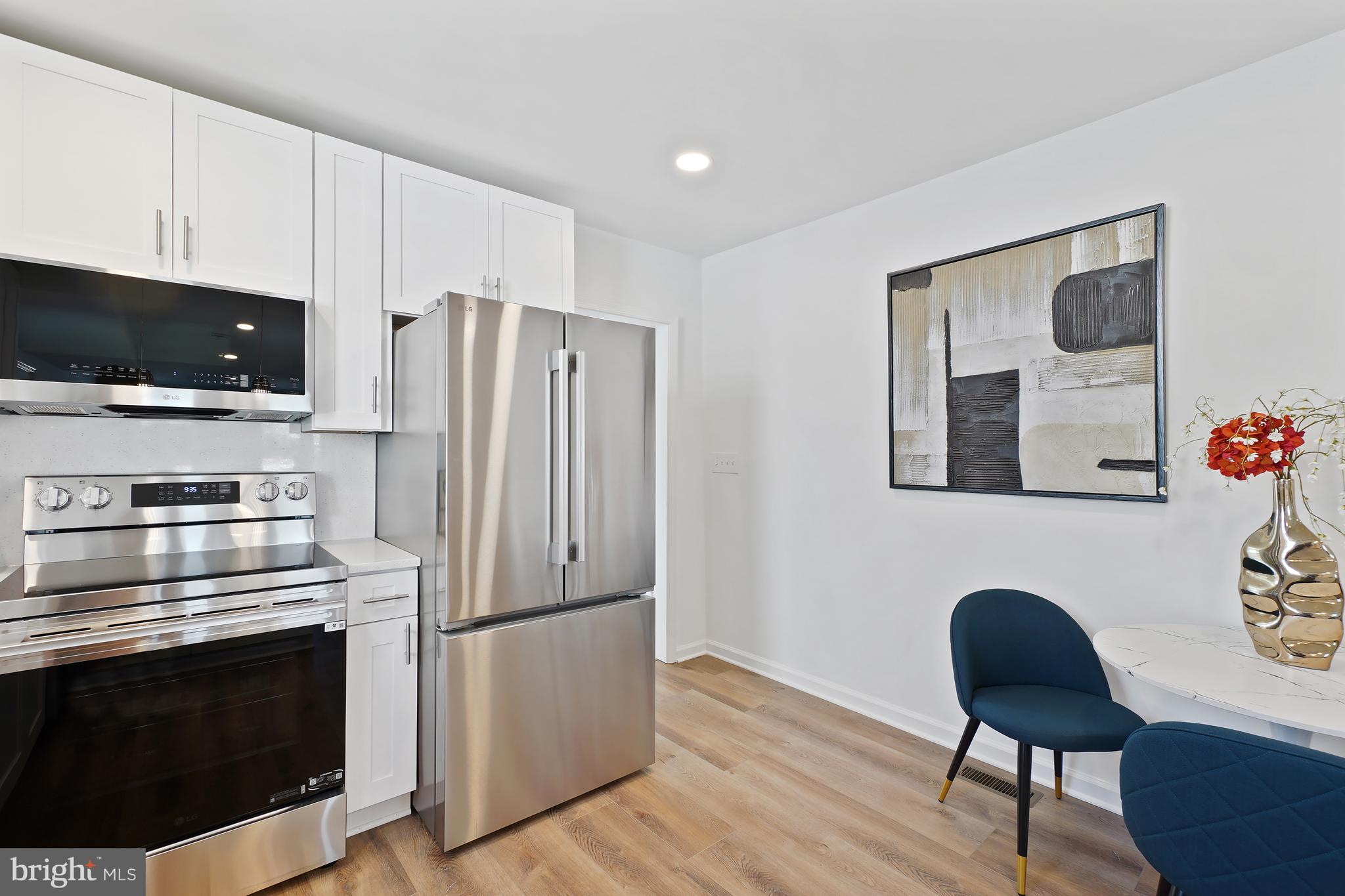 3731 Falls Road Baltimore, MD 21211 - Photo 7 of 30 a kitchen with stainless steel appliances a stove a refrigerator and a microwave